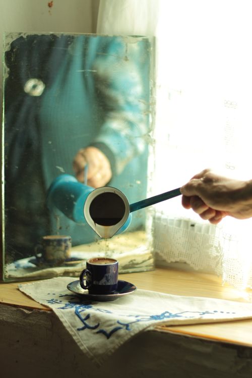 Free Authentic Turkish coffee poured into a cup by a sunlit window with a mirror reflection. Stock Photo