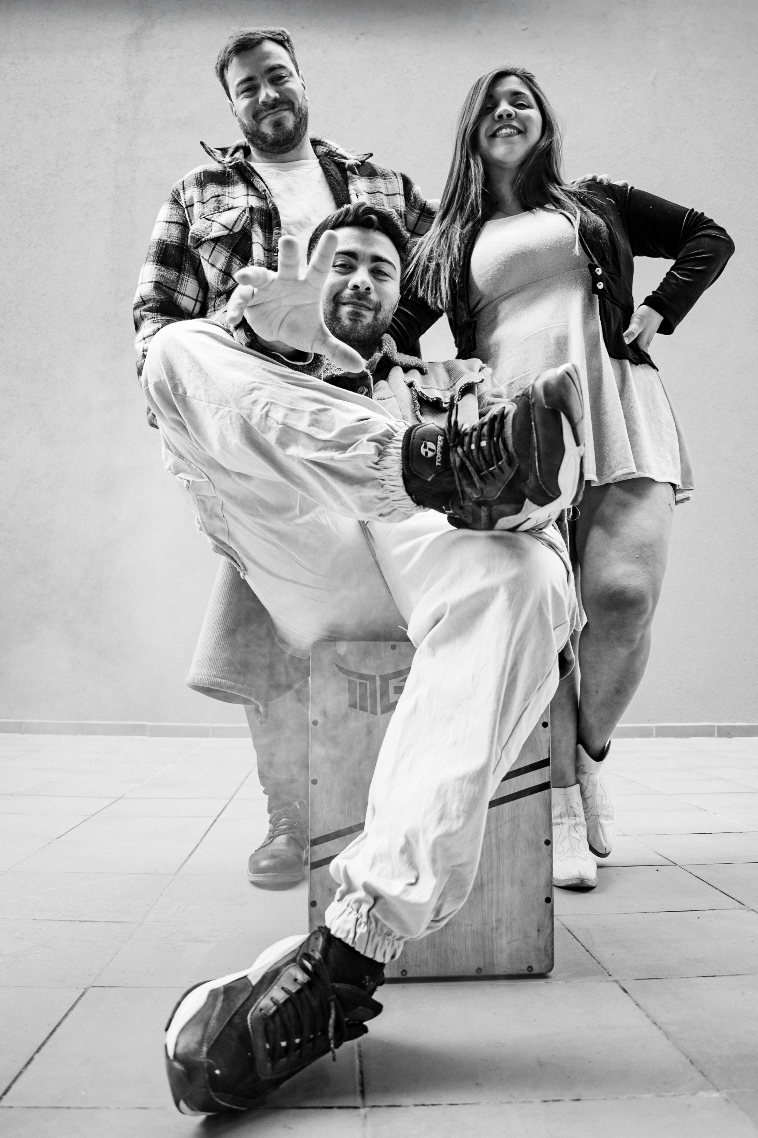 Black and white group portrait of three adults posing outdoors in Buenos Aires.