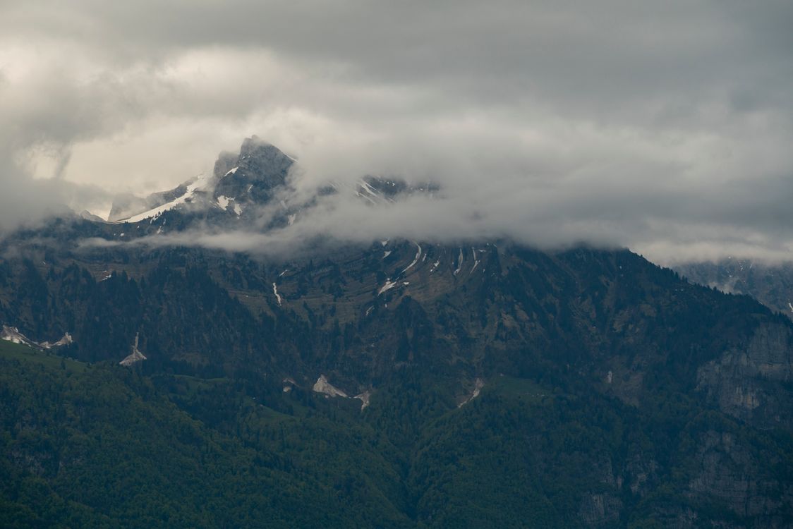 Dramatic Mountain Peaks Shrouded in Clouds · Free Stock Photo