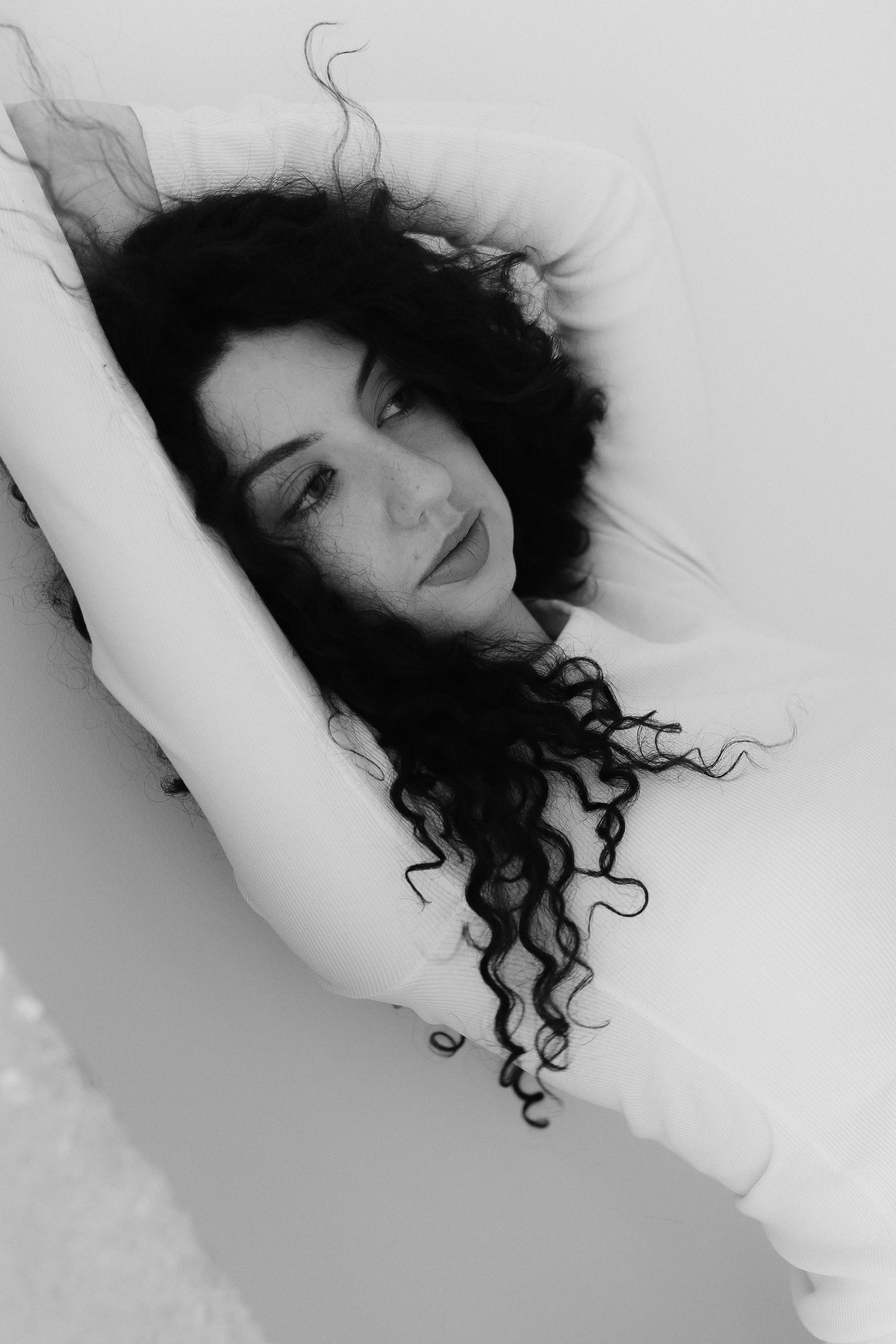 Black and White Portrait of Woman with Curly Hair · Free Stock Photo