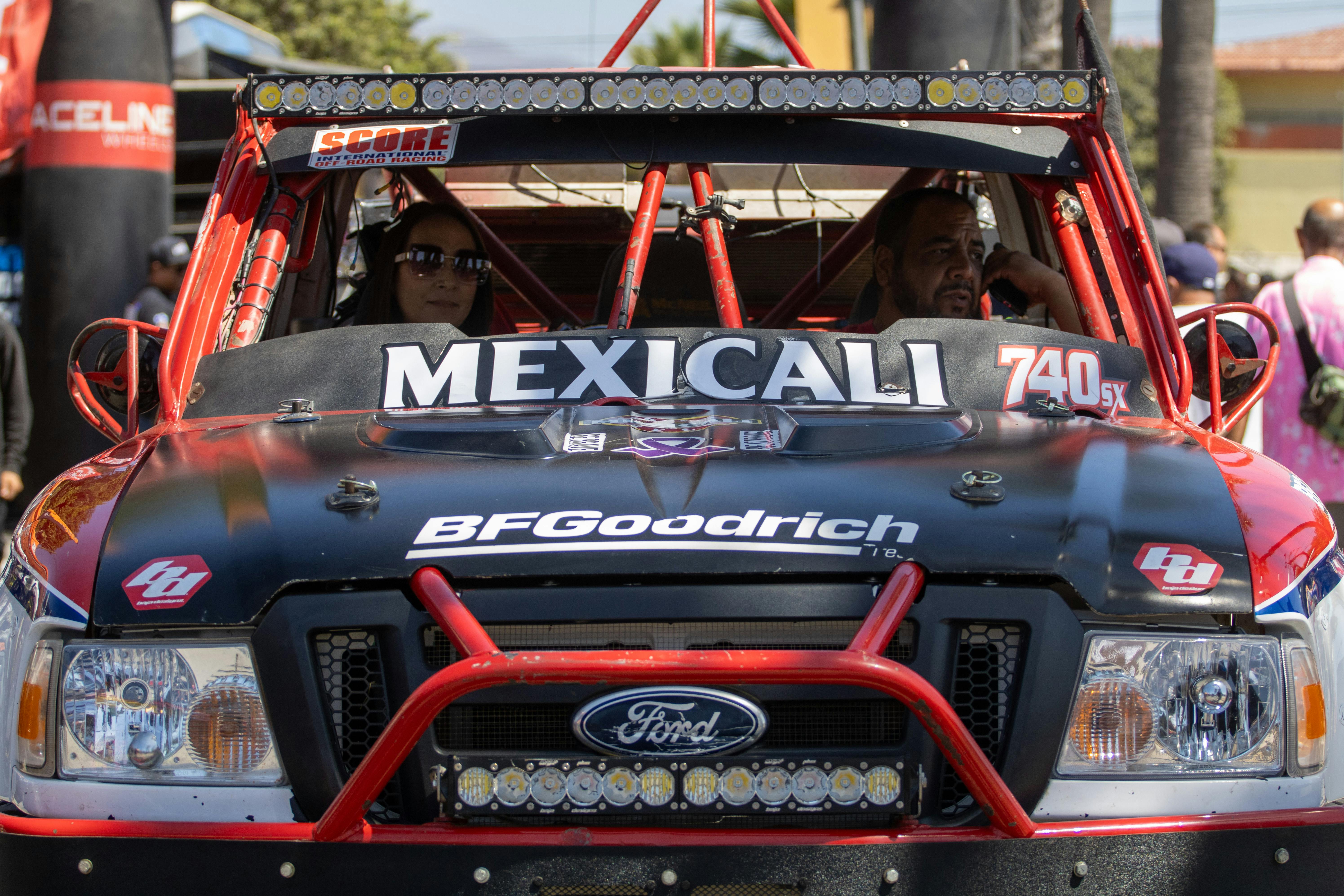 Close-up of a rally truck with drivers in Mexicali race event. Action-filled and dynamic.