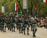 Mexican soldiers in camouflage marching during a parade in Mexico City.