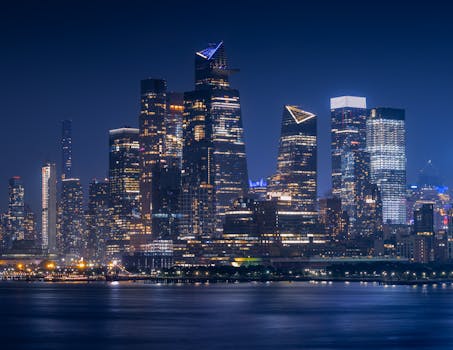 Stunning night view of New York City skyline with glowing skyscrapers.