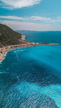 Stunning aerial shot of Antalya's coastline with vibrant blue waters and lush landscape.