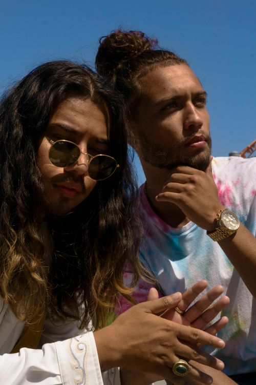 Free Two stylish young men in sunglasses enjoying a sunny day outdoors. Stock Photo