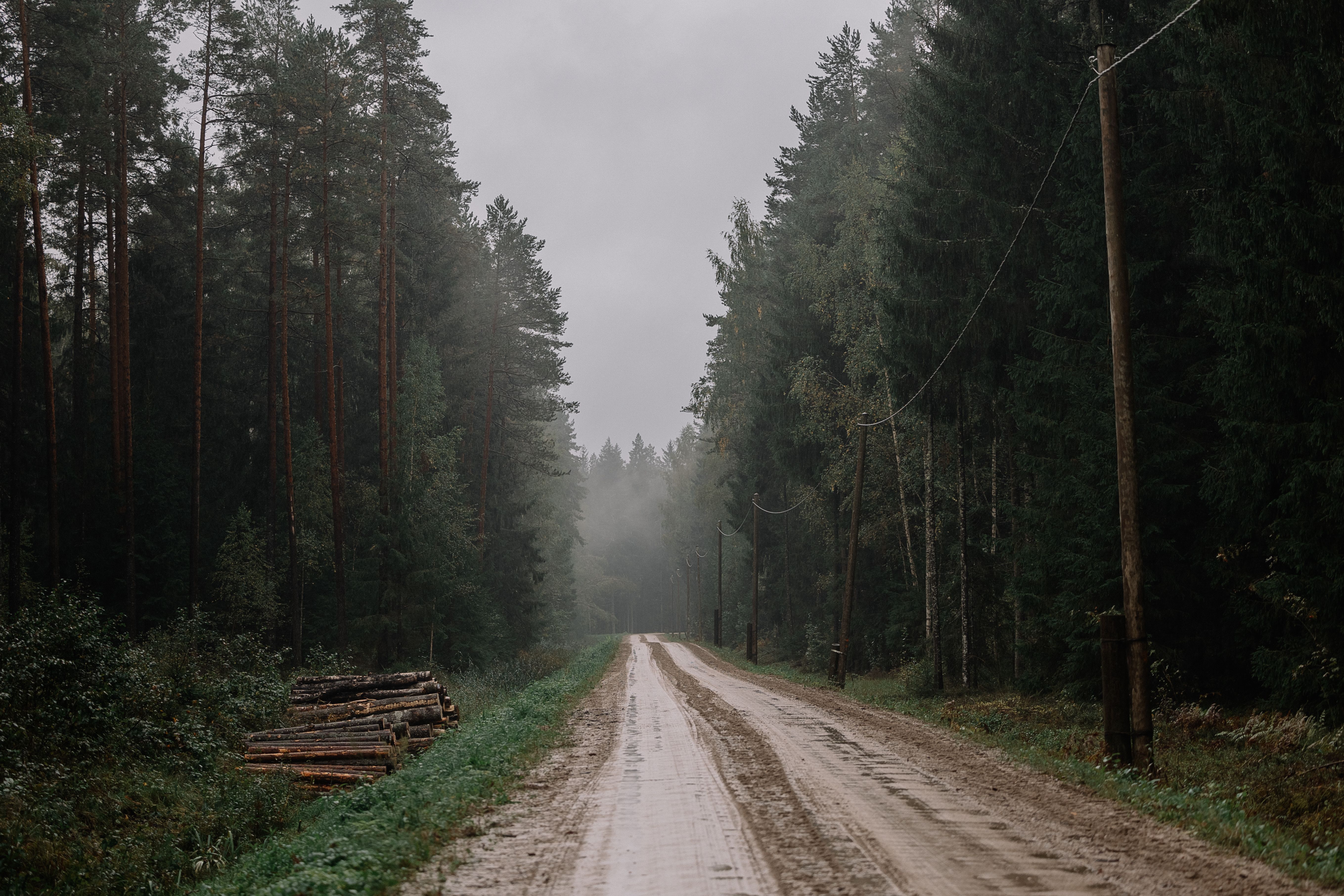 A rural medical clinic at the end of a dirt road, under overcast skies