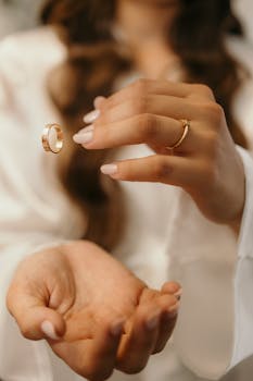 A close-up of hands with floating wedding rings, symbolizing love and unity.