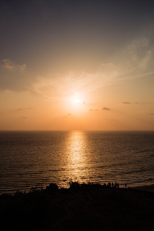 Free A tranquil sunset over the ocean at Chapora Beach in India, capturing a golden sky and calm waves. Stock Photo