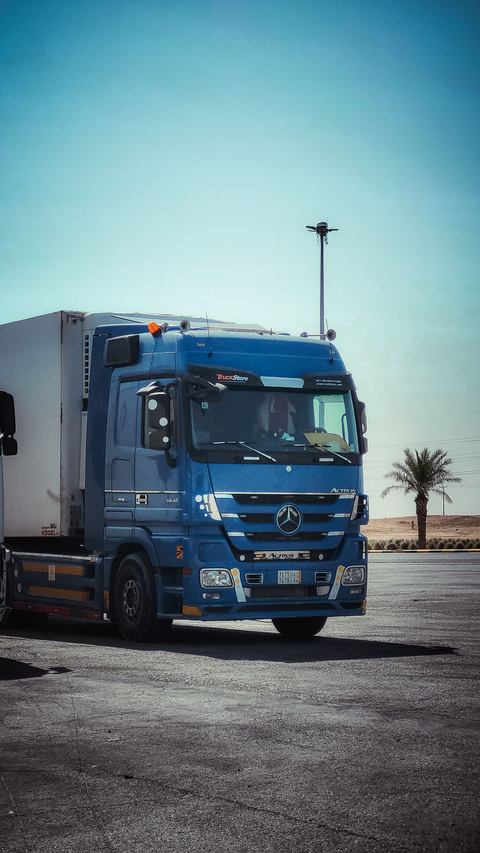 Blue freight truck on desert highway