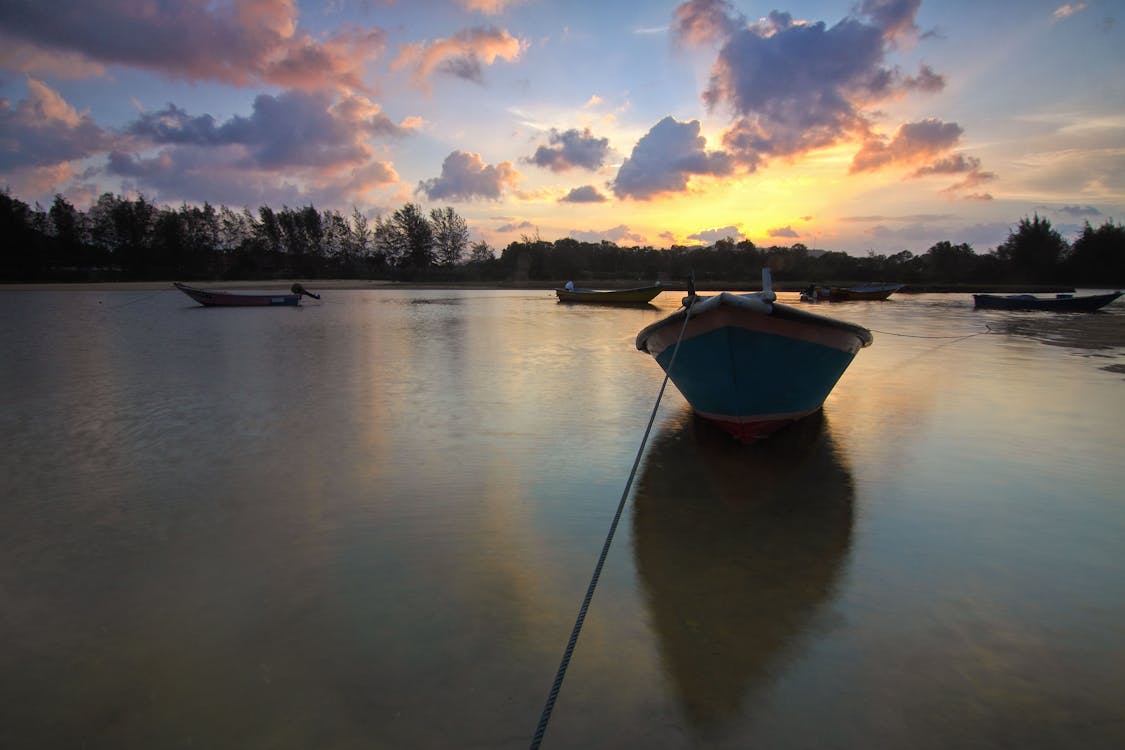 Silhouette of Boat on Body of Water