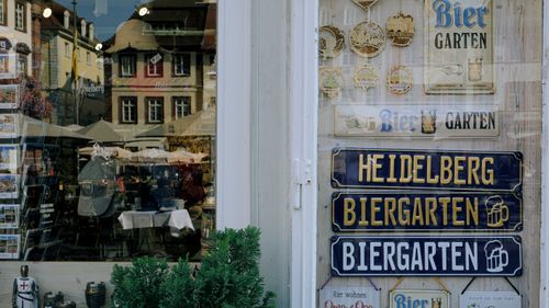 Free Charming Heidelberg Biergarten display showcasing vintage beer signs and local reflections. Stock Photo