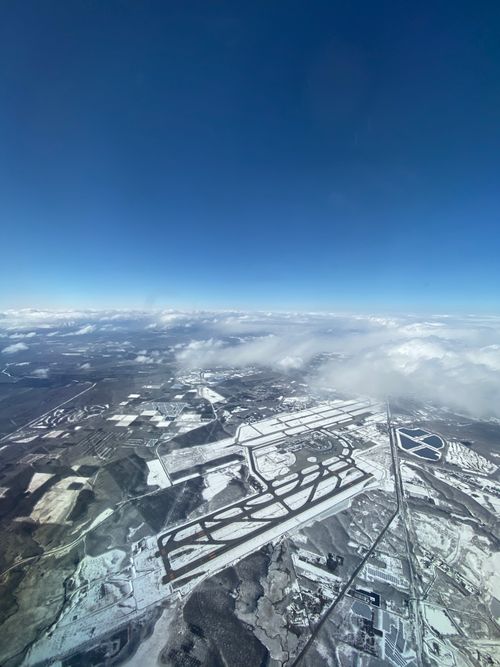 Free Stunning aerial shot of a snow-covered landscape in Chitose, Hokkaido under a clear blue sky. Stock Photo
