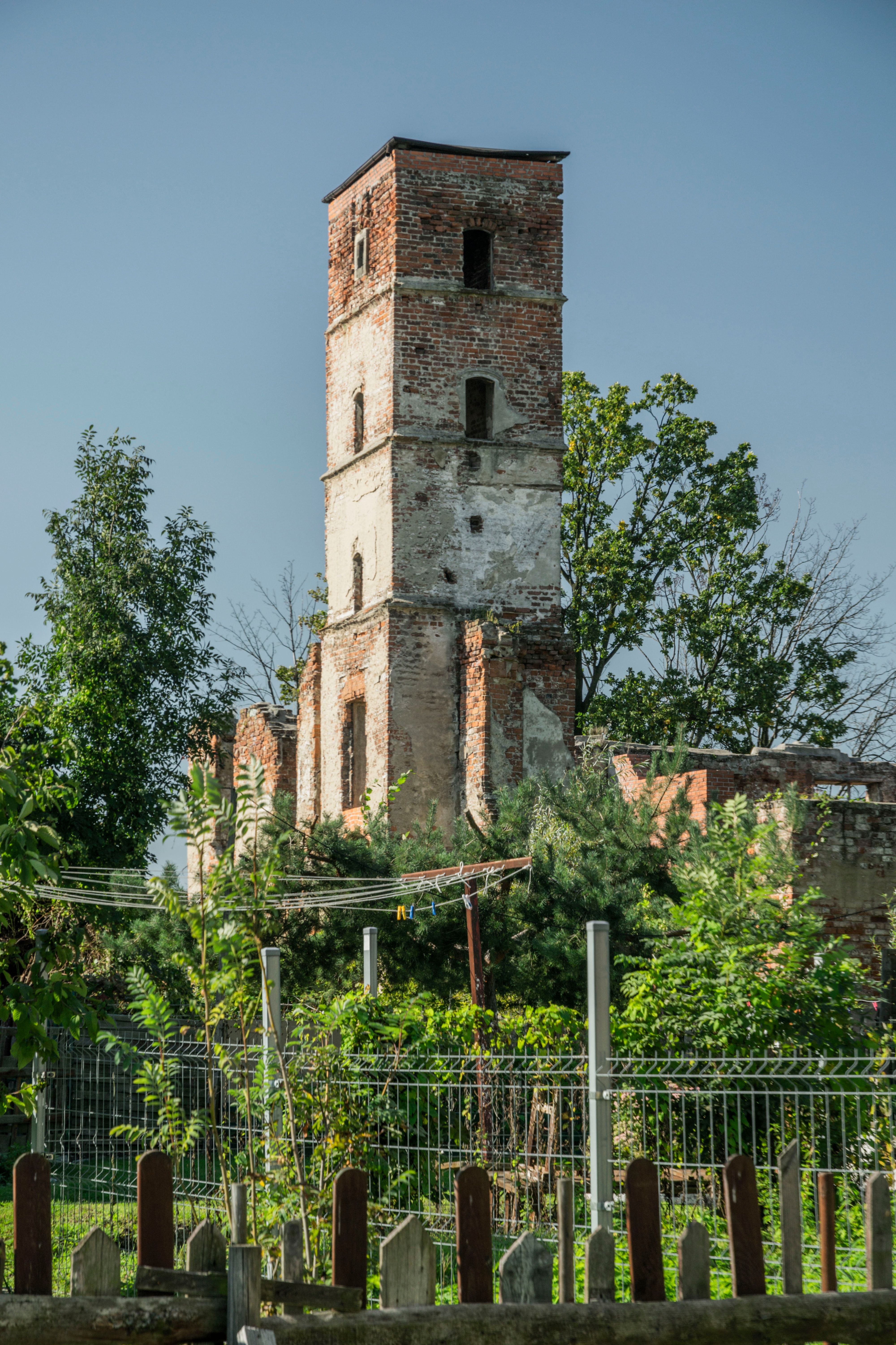 Explore the historical stone ruins of a tower in Smolec, Poland, set amidst lush greenery.