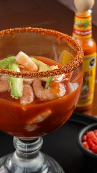 Savory shrimp cocktail with avocado served with spicy sauce, a gourmet seafood delight.