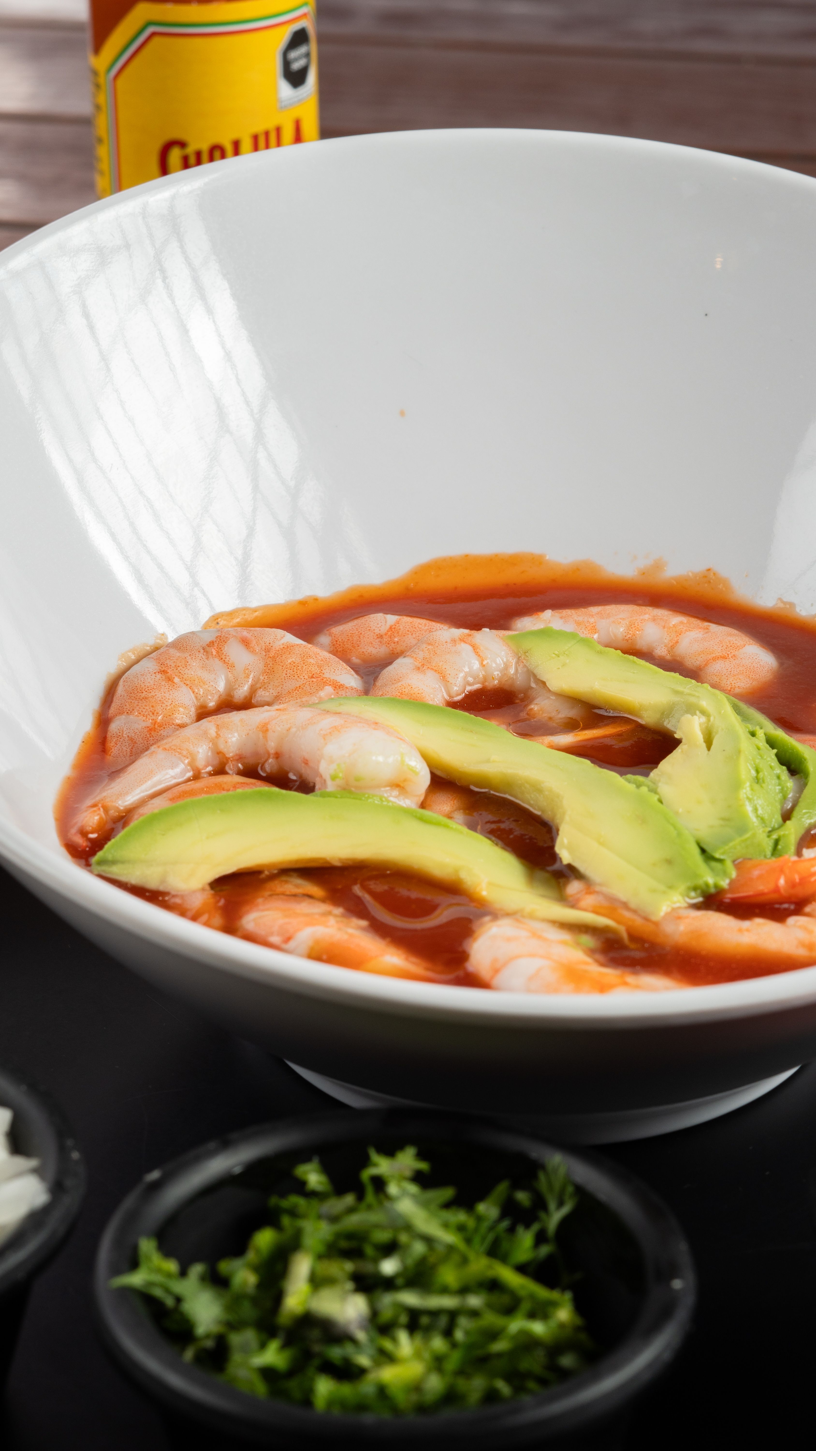 Shrimp cocktail with avocado slices served as a party appetizer