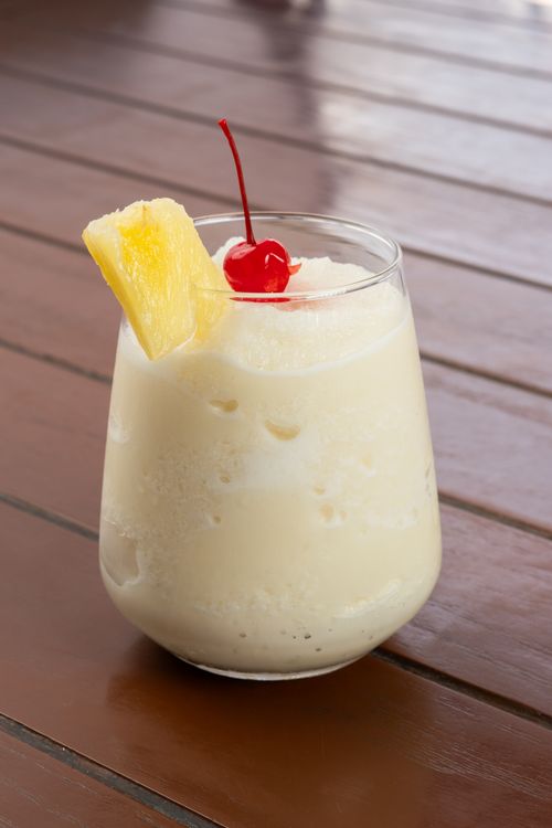 Free A refreshing piña colada served with pineapple slice and cherry, perfect for tropical vibes. Stock Photo