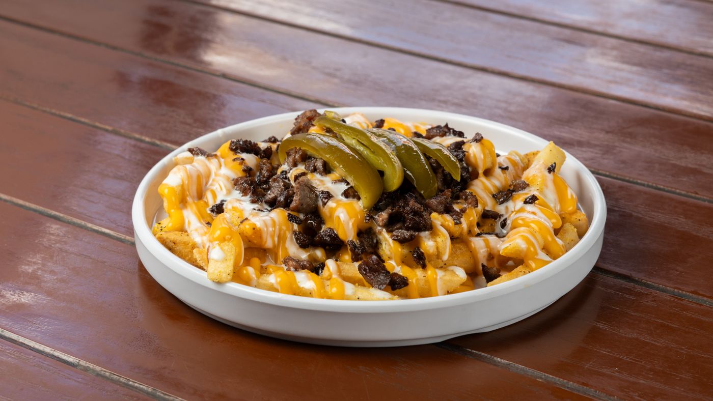 Loaded fries with steak, cheese, and jalapeños
