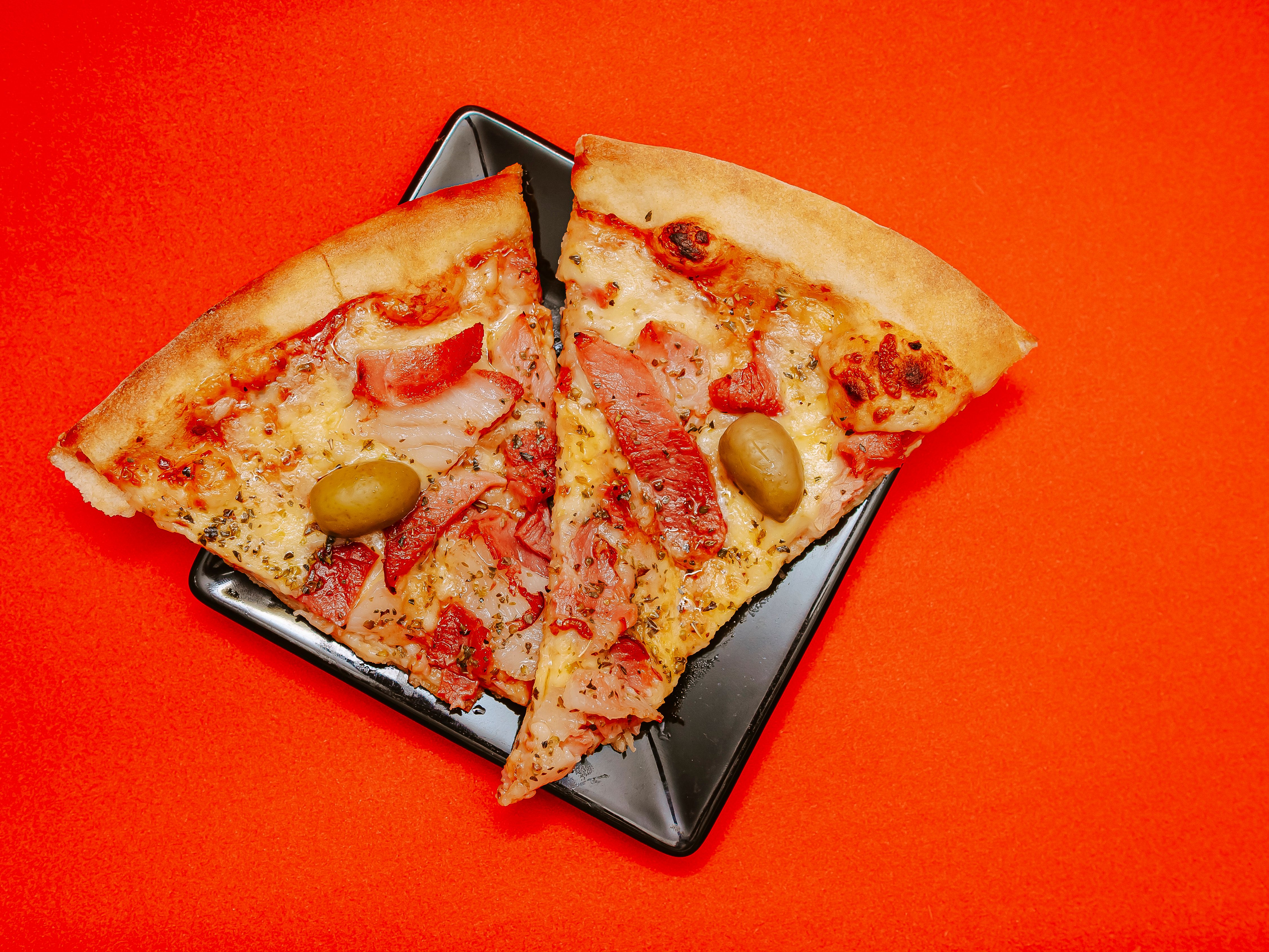 Chef slicing a giant pizza with a large pizza cutter