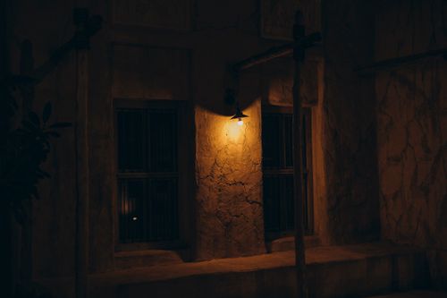 Free A warmly lit old Dubain architectural scene at night highlighting traditional Middle Eastern style. Stock Photo