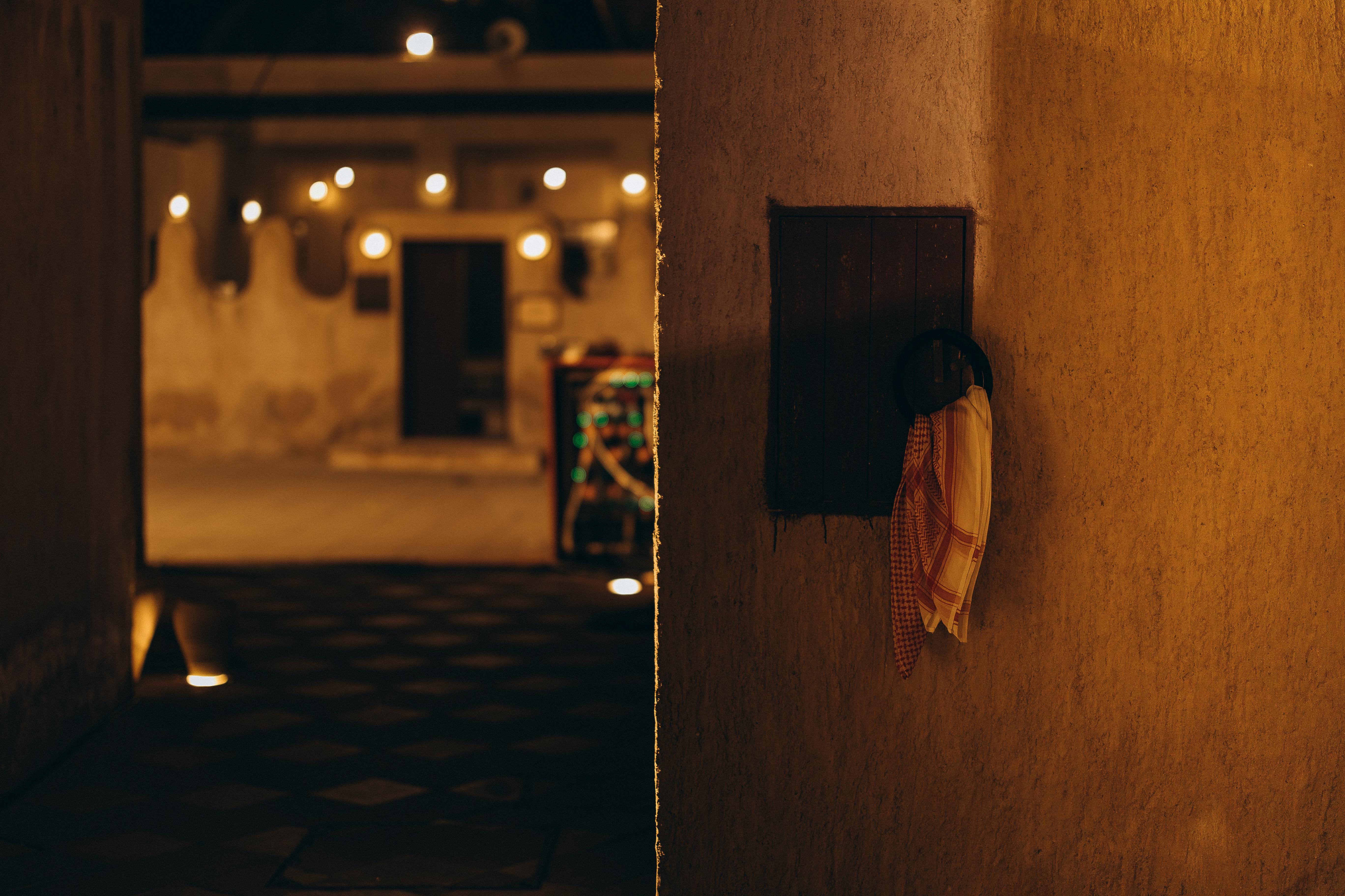 Free A warm-lit alley in Old Dubai showcasing cultural heritage and vintage architecture. Stock Photo