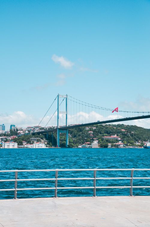 Free Vibrant daytime photo of Bosphorus Bridge spanning over water in Istanbul, with a clear blue sky. Stock Photo