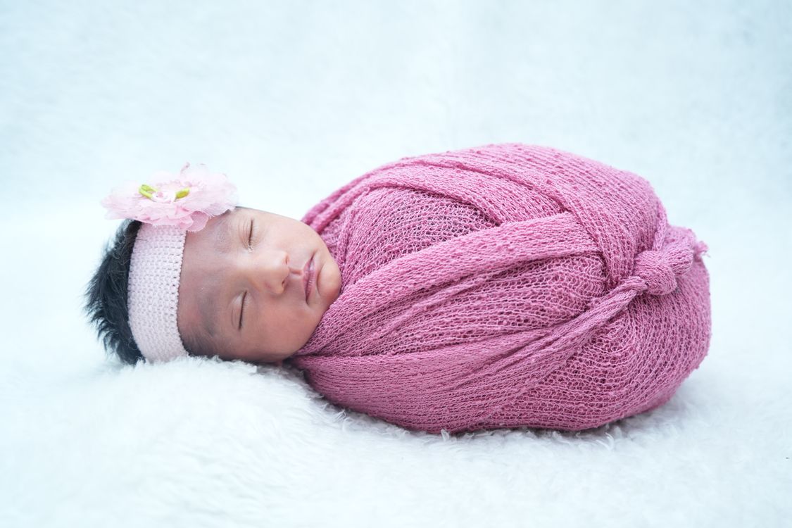 Adorable Newborn Baby Wrapped in Pink Blanket · Free Stock Photo