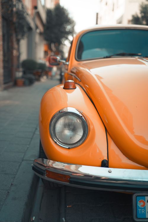 Free Close-up of a vintage orange Beetle car parked on a picturesque Istanbul street. Stock Photo