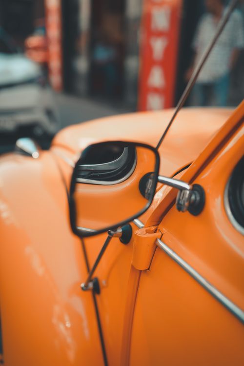 Free Close-up of a vintage yellow car's side mirror on a street in İstanbul, Türkiye. Stock Photo