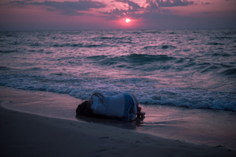 Photo Of Person Lying Down On Beach