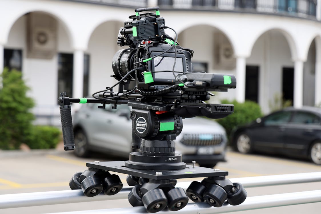 Professional Camera Rig on Dolly Track Outdoors · Free Stock Photo