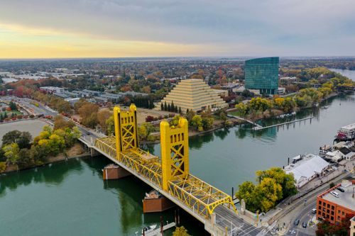 Free Aerial photo showcasing Sacramento's yellow Tower Bridge over the Sacramento River. Stock Photo