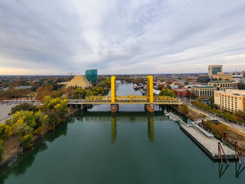 Free Scenic aerial shot of Sacramento's Tower Bridge over the Sacramento River in the fall season. Stock Photo