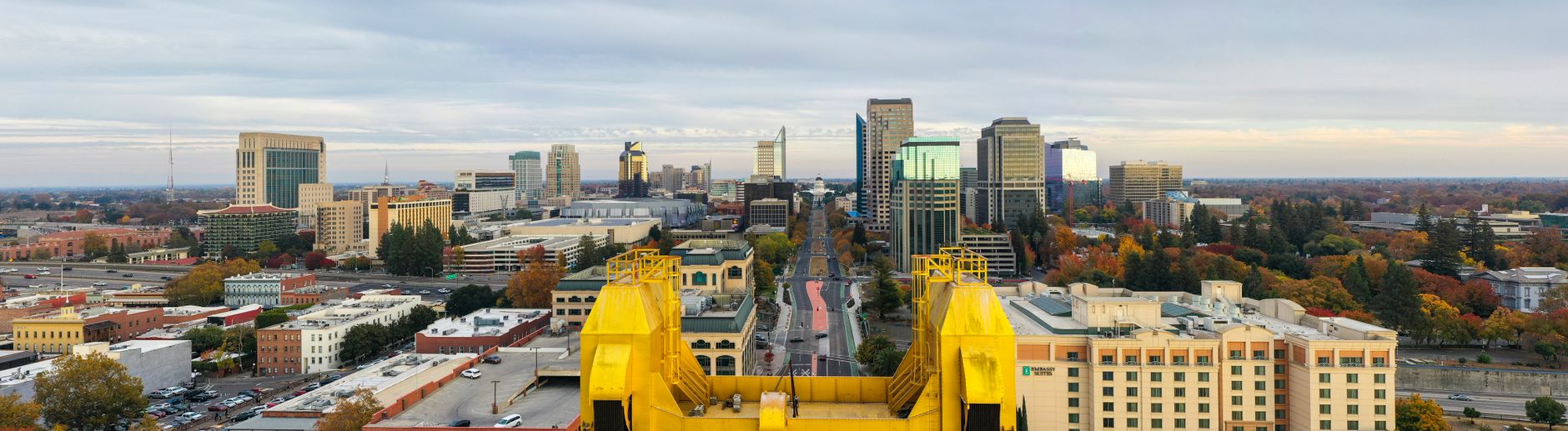 Panoramic view of Sacramento's skyline featuring iconic landmarks and vibrant autumn colors.