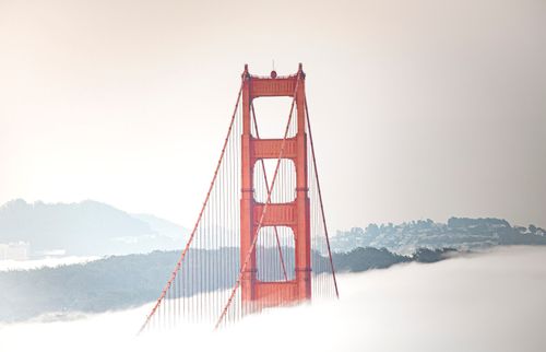 Free Iconic view of the Golden Gate Bridge emerging from morning fog in San Francisco. Stock Photo