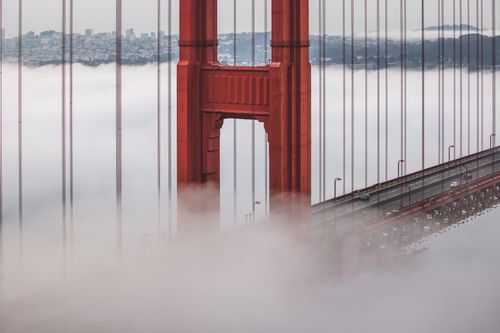 Free View of Golden Gate Bridge enveloped in fog, showcasing architecture's elegance. Stock Photo