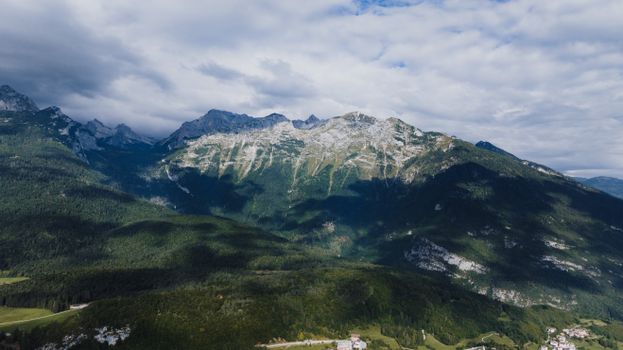 Breathtaking landscape of Dolomite mountains in Molveno, Italy with lush greenery.