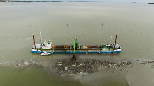 Free Aerial view of a dredging barge in the Venice lagoon performing excavation work. Stock Photo