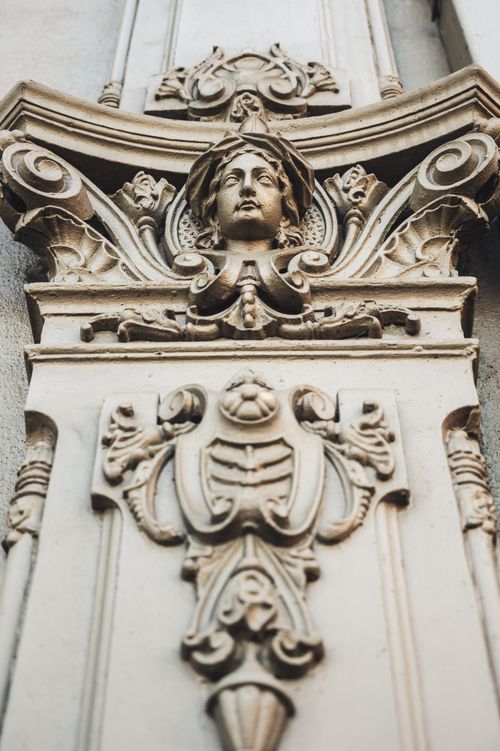 Free Close-up of intricate Gothic architectural sculpture featuring ornate carvings and a human bust. Stock Photo