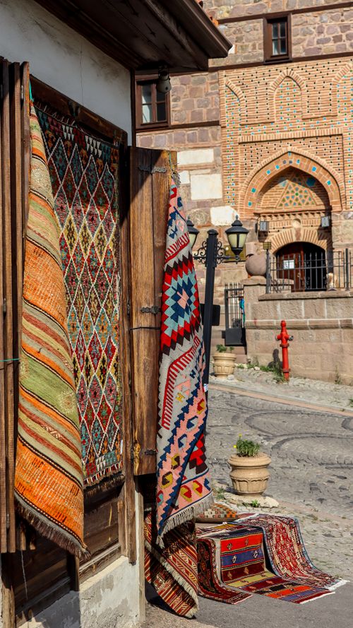 Free Colorful Turkish carpets hanging outside a traditional shop on a sunny day. Stock Photo