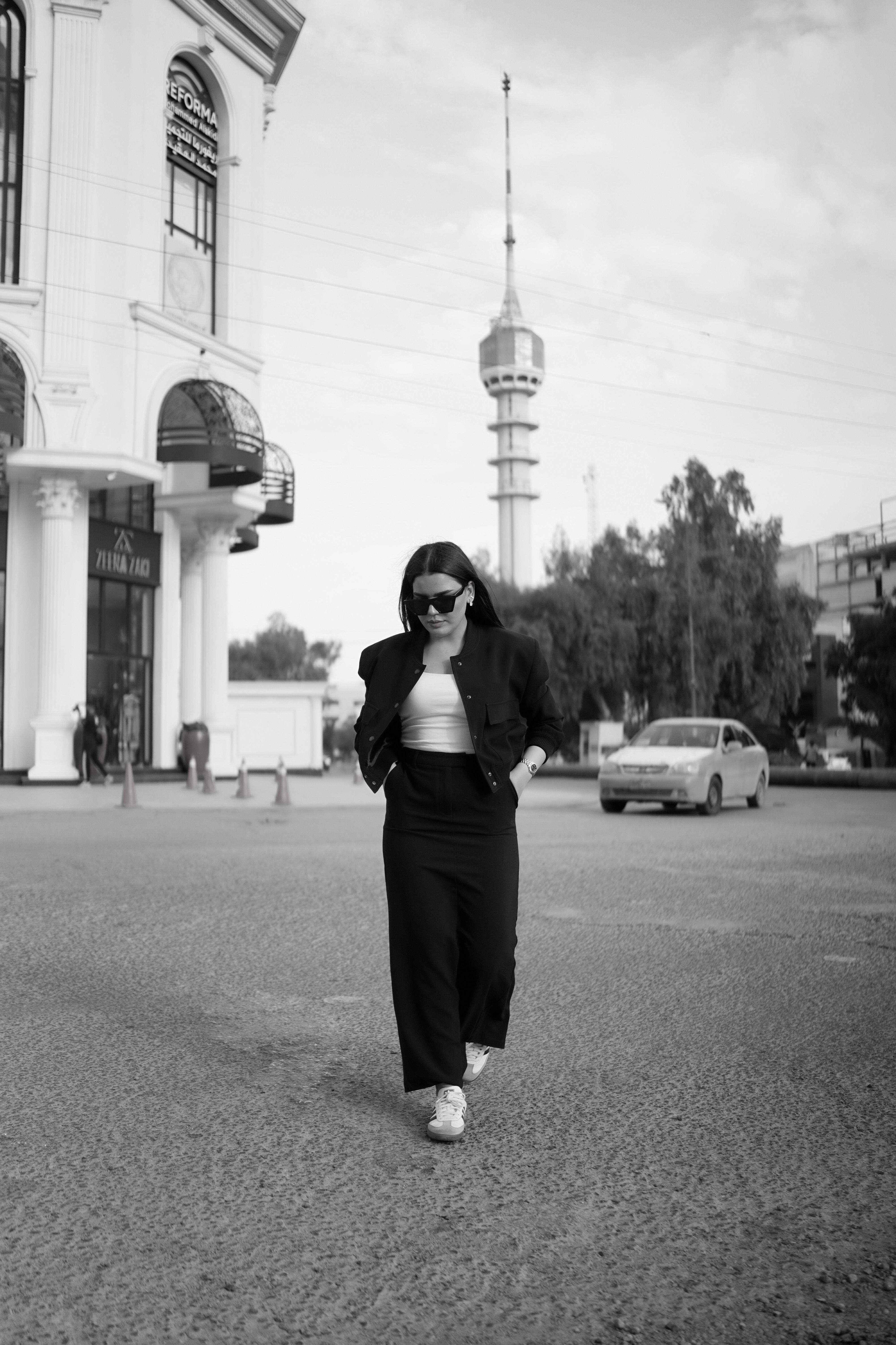 Stylish woman walking confidently in city street.