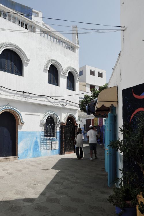 Free Whitewashed buildings and narrow street in Asilah, Morocco, capturing local architecture. Stock Photo