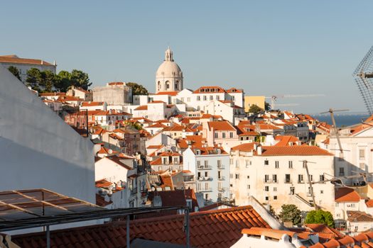 A scenic view of Lisbon's historic architecture and vibrant rooftops under a clear sky.