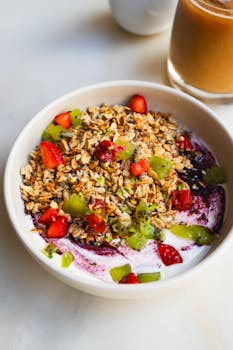 Delicious granola breakfast bowl topped with fresh fruits and yogurt, perfect for a healthy morning meal.