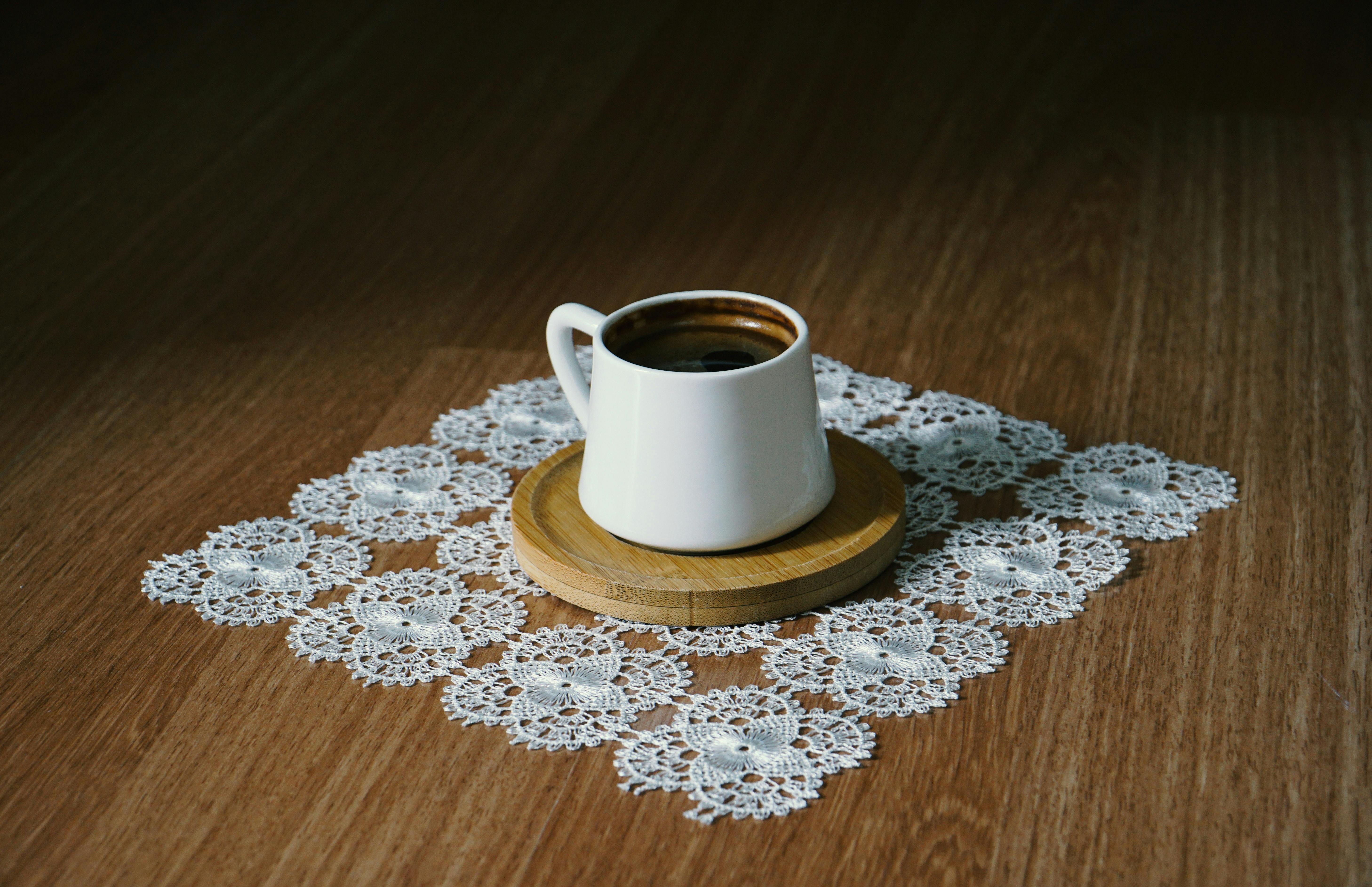 A cup of authentic Turkish coffee in a white cup on lace doily.