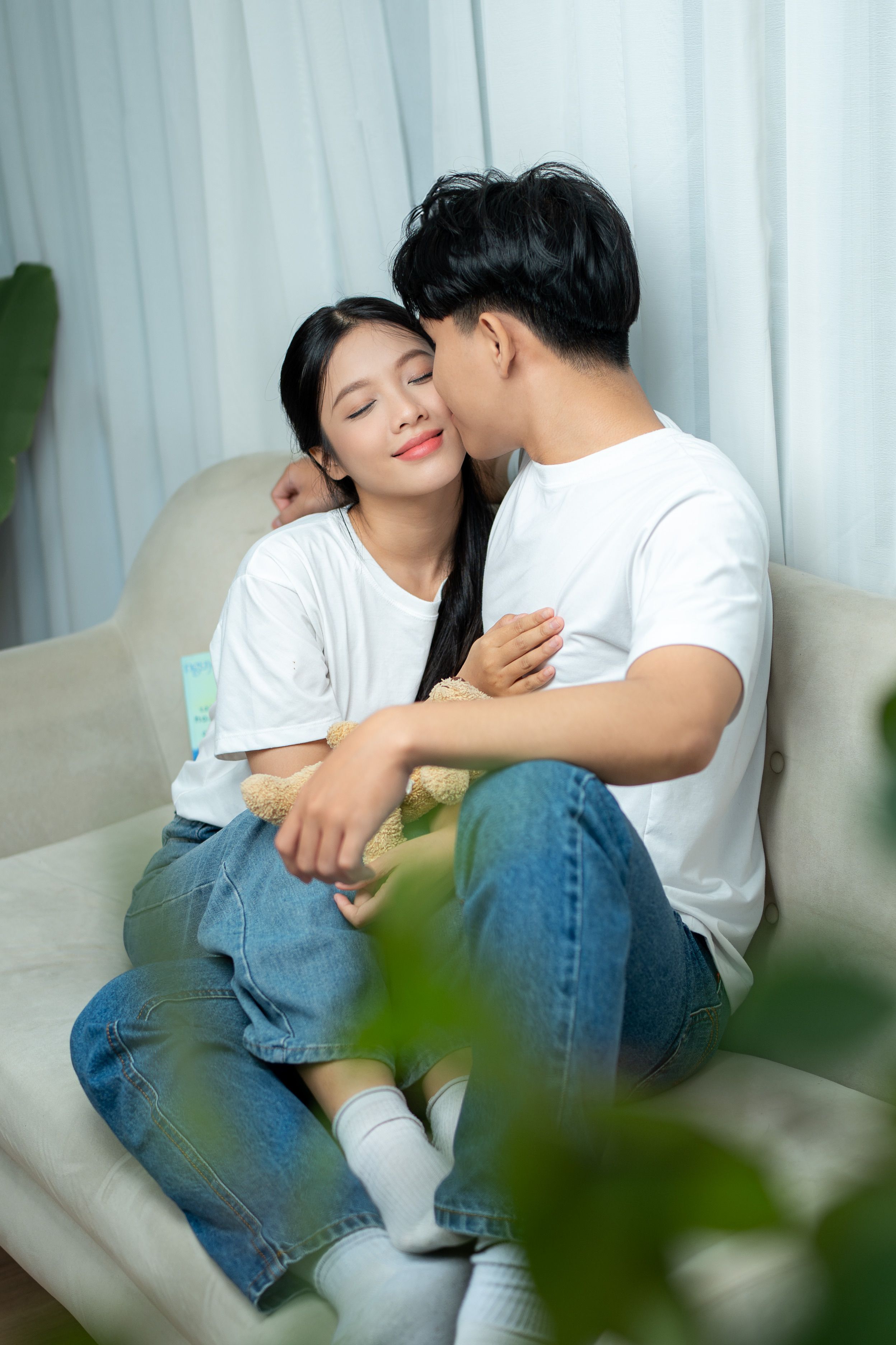 Romantic Couple Relaxing on a Cozy Sofa Indoors · Free Stock Photo