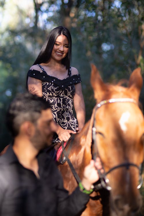 Free Woman in  Black and Gray Halter Dress Horse Back Riding Stock Photo