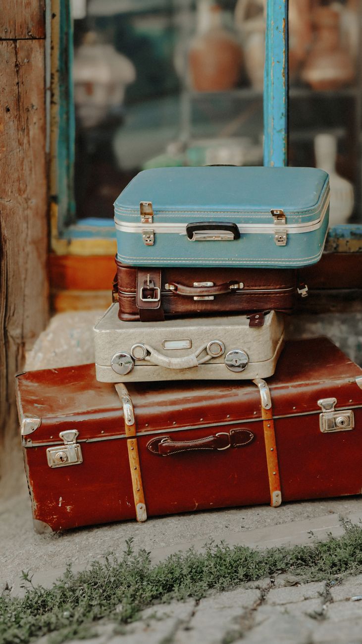 Vintage suitcases stacked outdoors, ready for a trip