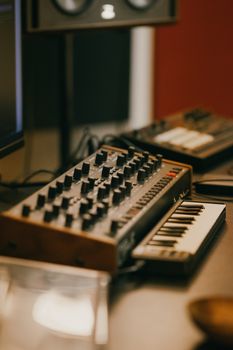 Close-up of synthesizer and keyboard in a modern music studio setting.