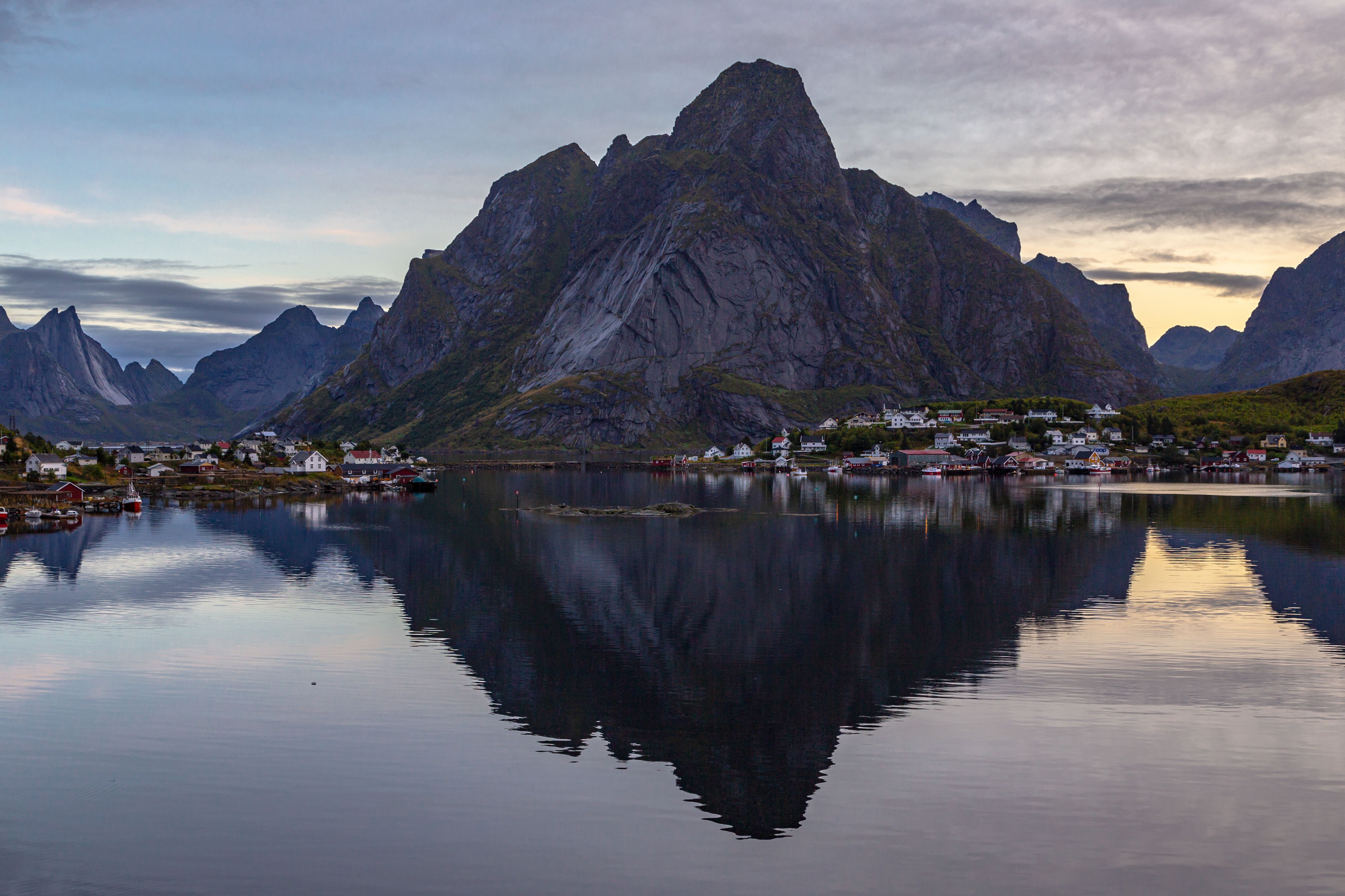 lofoten norway reine village reflection red rorbuer mountains midnight sun fjord dramatic