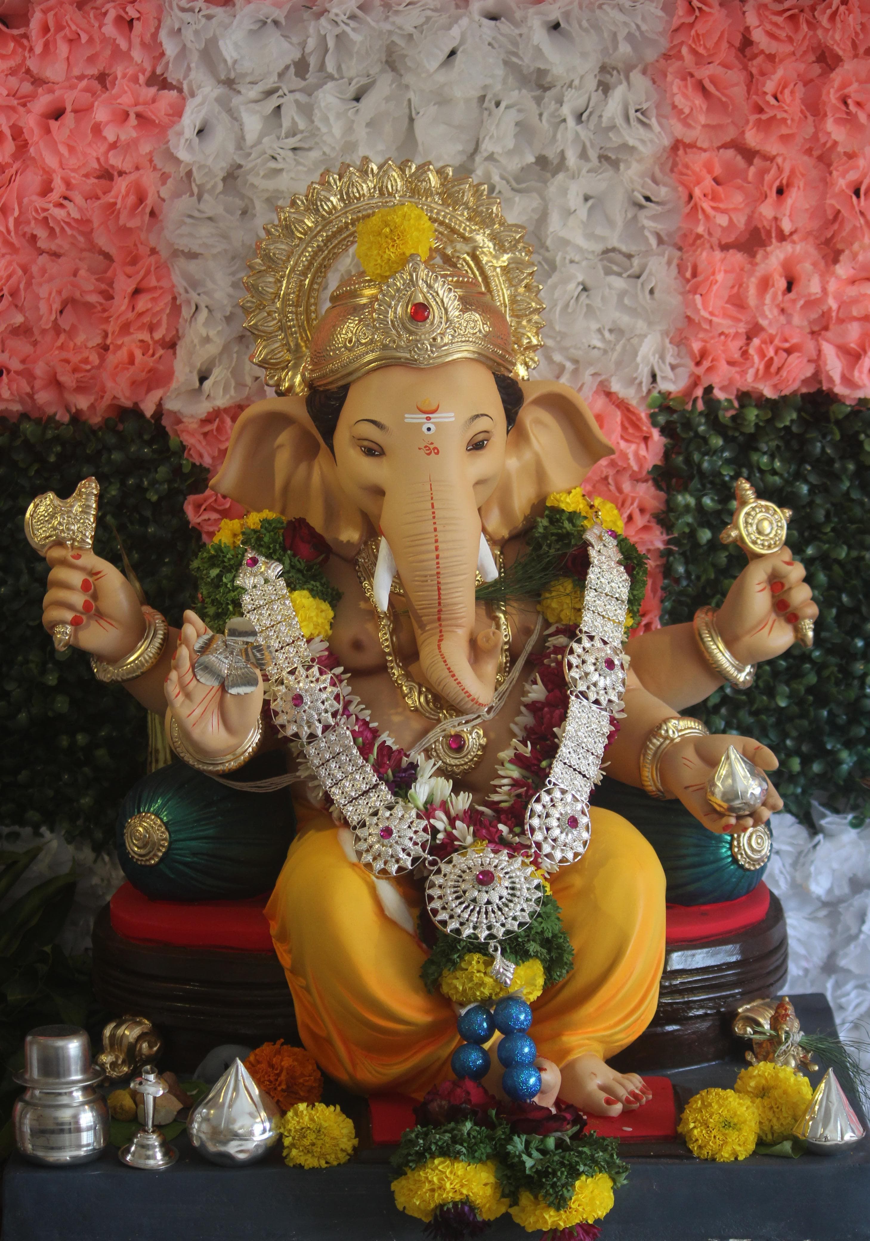 Beautifully adorned Lord Ganesha idol with floral decorations in Pune, India.